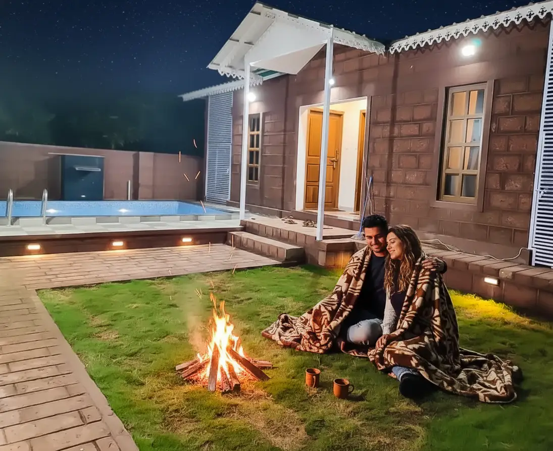 Best Place to Stay in Mahabaleshwar for Couples Couple near bonfire at romantic Mahabaleshwar resort